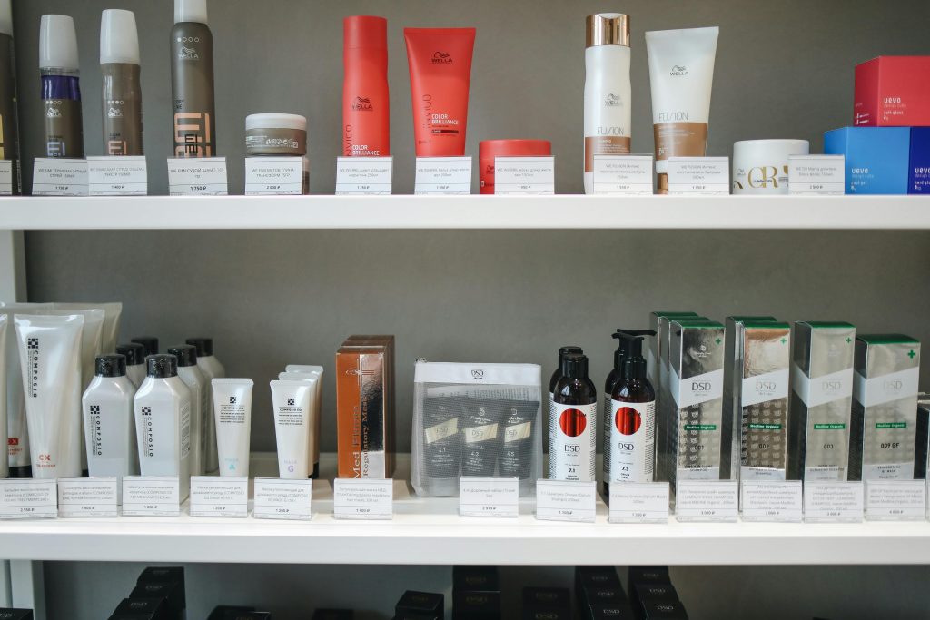 Assorted skincare and beauty products neatly displayed on shelves in a store setting.